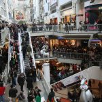 A photo of a multi-level shopping mall with lots of people