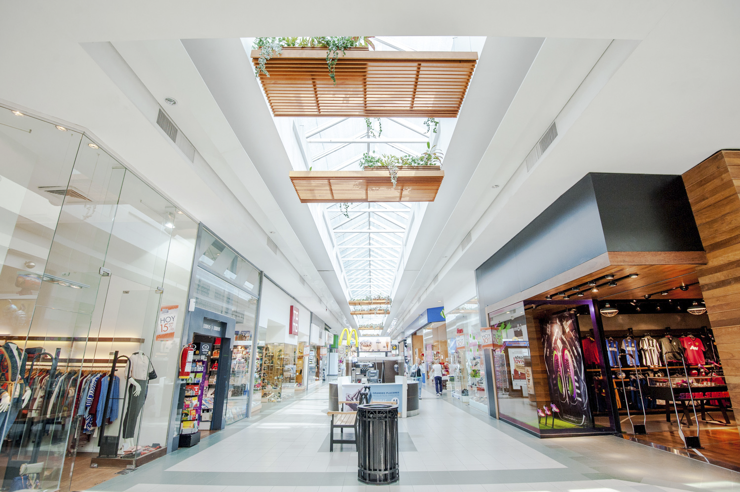 A photograph of Portones Shopping Mall showing walkway with storefronts on either side.