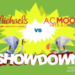 A graphic with a yellow starburst in the center and two robots charging towards each other. Both are carrying arts and crafts supplies, like paint brushes and plants. Text reads "AlertBot Showdown: Michaels vs A.C. Moore" with the word SHOWDOWN very large at the bottom.