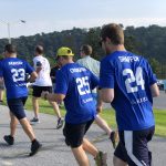 Runners with numbers on the back of their shirts participating in an event