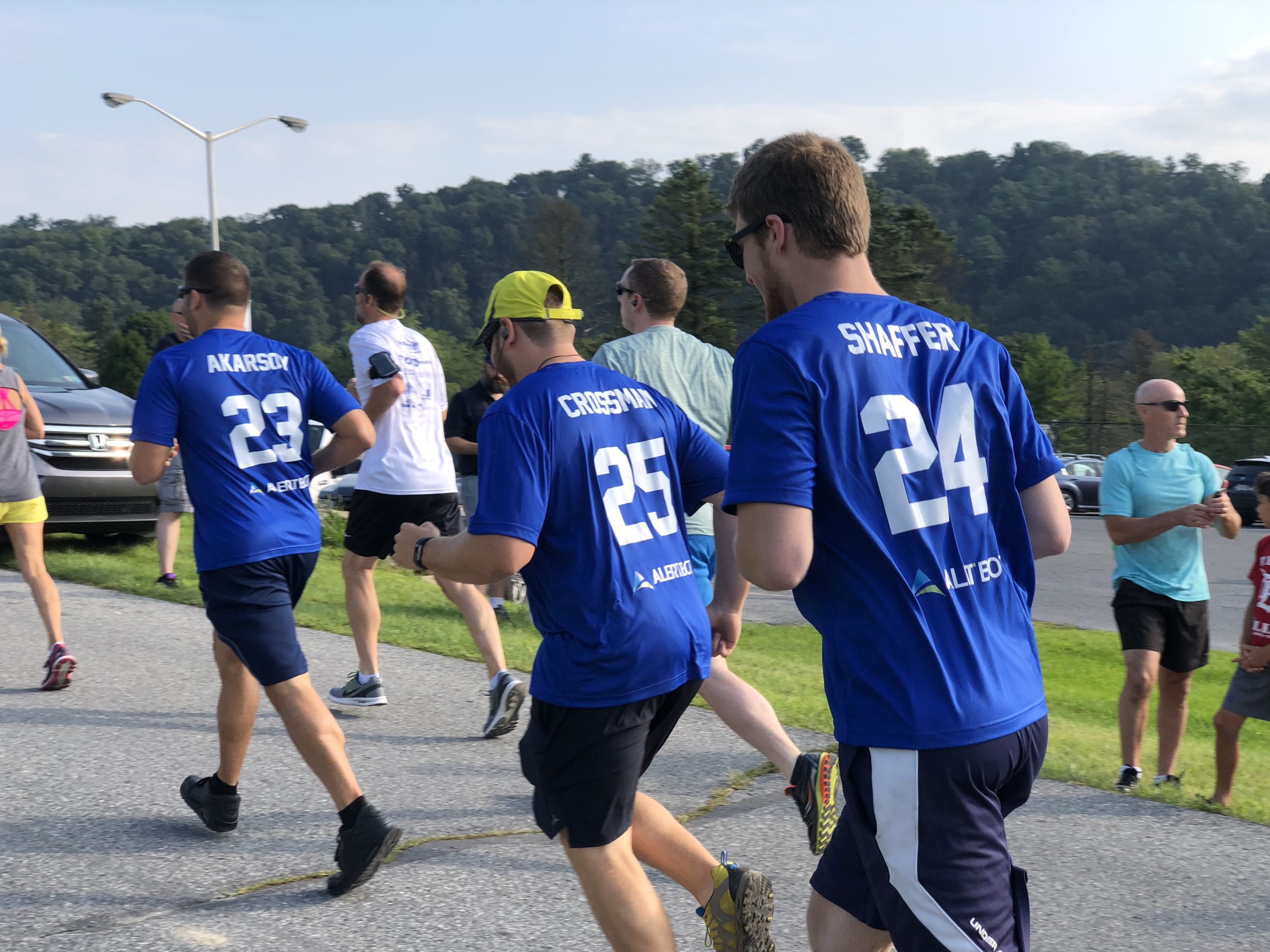 Runners with numbers on the back of their shirts participating in an event