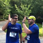 Two men with their hands up to give each other a high five