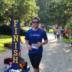 A male runner crossing the finish line