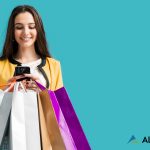 A beautiful woman with brow n hair holding and looking at her cellphone, with five shopping bags also in her hands. Text on the image reads "6 Tips to Prepare Your E-Commerce Site for the Biggest Holiday Traffic Surge Ever"