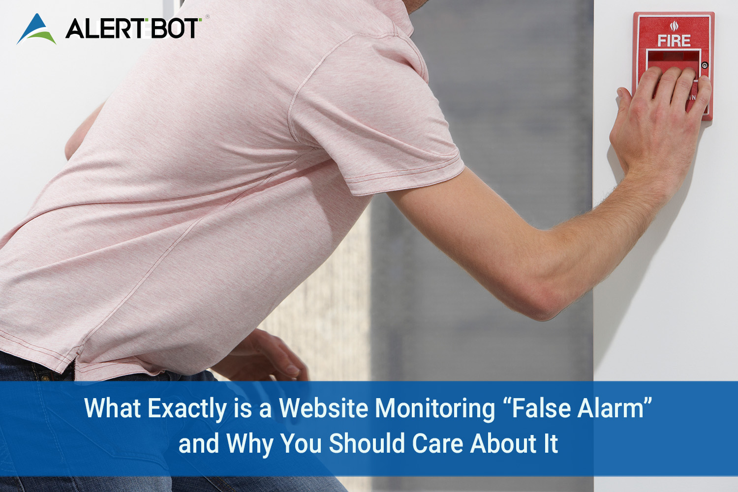 A man in a rose colored polo shirt leaning over with his hand on a fire alarm, about to depress the button.